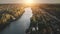 Sunrise over cottages at river shore aerial. Autumn nobody nature landscape. Cityscape buildings