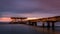 Sunrise over a decayed pier