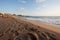 Sunrise over a deserted sandy beach.