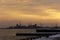 Sunrise over docks and heavy industry port, birds