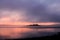 Sunrise over Drakes Island, with fog clearing in Plymouth Sound, Devon