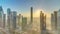 Sunrise over Dubai skyline in the morning, aerial top view to downtown city center landmarks timelapse.