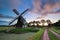 Sunrise over Dutch windmill in summer