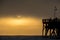 Sunrise over a fishing Pier and Fishermen