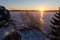 Sunrise over frozen and snowy lake