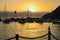 Sunrise over Harbor with Boats and Flag and Seagull in Profile o