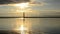 Sunrise over harbor with lighthouse.