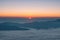 Sunrise over horizon with mountain and foggy in morning