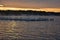 Sunrise Over a Lake with Docks in the Mist Rising Above the Water