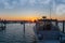 A sunrise over the Lexington Harbor with a boat in the foreground in Lexington