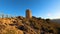 Sunrise over Mediterranean sea. Historic Torre Vigia De Cerro Gordo, a watchtower looking out for any marauding pirates