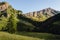 Sunrise over the mountain meadows, trees and peaks  of the italian alps, in piedmont