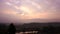 Sunrise over mountains with country side farming fields and orange dramatic sky at dawn at village