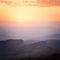 Sunrise over the mountains and the forest at dawn