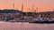 Sunrise over Old Venetian harbour of Chania, Crete, Greece. Sailing boats anchored by pier, Old Venetian shipyards or