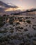 Sunrise over the rugged rocky coastline with Llandudno Pier in the background - North Wales