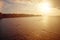 Sunrise over Salthill beach. Silhouette of people swimming in the ocean. Warm tone. Galway city, Ireland. View from Blackrock