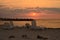 Sunrise over sea beach with deck chairs