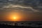 Sunrise over the sea with beautiful clouds. People meeting the dawn of the sea landscape,