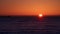 Sunrise over the sea. On the horizon you can see cargo ships