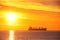 Sunrise over the sea with sailing cargo ship. Transportation. Logistics. Shipping.