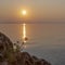 Sunrise over the sea and the silhouette of a flower in its rays. Corfu island, Greece. Background. Space for text