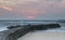 Sunrise over the South Pier and entrance to Cullercoats Bay on the North East Coast of England.