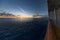 Sunrise over water from cruise ship balcony veranda