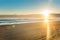 Sunrise over wide flat sandy beach at Ohope Whakatane