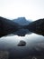 Sunrise panorama mirror reflection view of alpine forest mountain lake Piburger See Oetztal Alps Tyrol Austria Europe