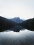 Sunrise panorama mirror reflection view of alpine forest mountain lake Piburger See Oetztal Alps Tyrol Austria Europe