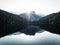 Sunrise panorama mirror reflection view of alpine forest mountain lake Piburger See Oetztal Alps Tyrol Austria Europe