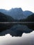 Sunrise panorama mirror reflection view of alpine forest mountain lake Piburger See Oetztal Alps Tyrol Austria Europe