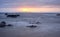 Sunrise in Pink Sunlight East Coast Tasmania Slow shutter speed water over rocks