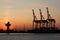 Sunrise and the port cranes