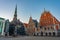 Sunrise at Ratslaukums square with Saint Peter church and House