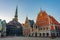 Sunrise at Ratslaukums square with Saint Peter church and House