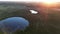 Sunrise rays shining through, Aerial drone view of sunrise over misty landscape.