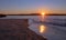 Sunrise reflections over tidal outflow of the Santa Clara river estuary at McGrath State Park of Ventura California USA