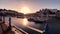 Sunrise reveal at Torquay Harbour metal fence by anchored boats, English Riviera, England