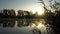 Sunrise on the riverbank. Landscape with closeup reeds on the right first plan and smoke on the water