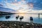 Sunrise rocky shore with fishing boat