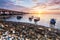 Sunrise rocky shore with fishing boat