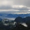 Sunrise scene seen from Mount Brienzer Rothorn. View towards Stanserhorn and Lucerne. Fog lifting slowly after a rainy night