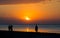 Sunrise by the sea. People admire the sunrise on the beach