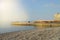 Sunrise on the sea with sun glare, pier on the shore in the early morning, calm, rest, summer holiday concept