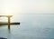 Sunrise on the sea with sun glare, pier on the shore in the early morning, calm, rest, summer holiday concept