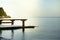 Sunrise on the sea with sun glare, pier on the shore in the early morning, calm, rest, summer holiday concept