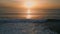 Sunrise sea surf washing beach drone view. Golden dawn sky ocean water surface