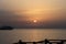 Sunrise on the sea. Wooden piles and little ship. Morning sun rays. Red sea, Safaga, Egypt